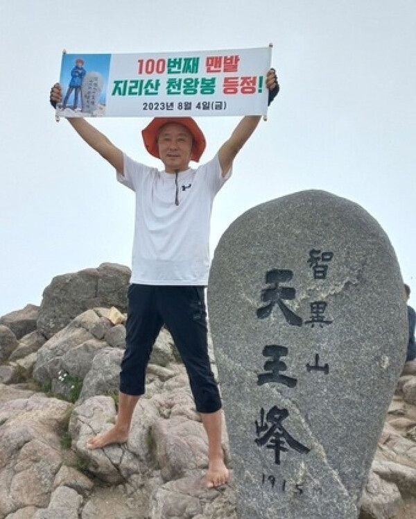 황인태 회장이 맨발로 지리산 천왕봉을 올라 기념사진을 촬영하고 있다(경남미디어 제공).
